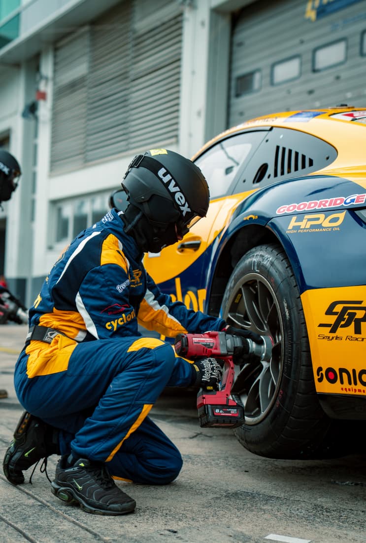 Mechanic working on the race car in the pit lane