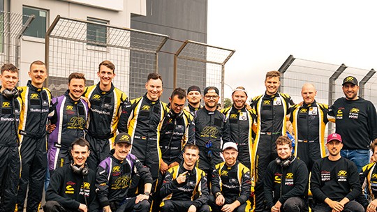Team and driver photo of Smyrlis Racing at the ADAC archway at the Nürburgring