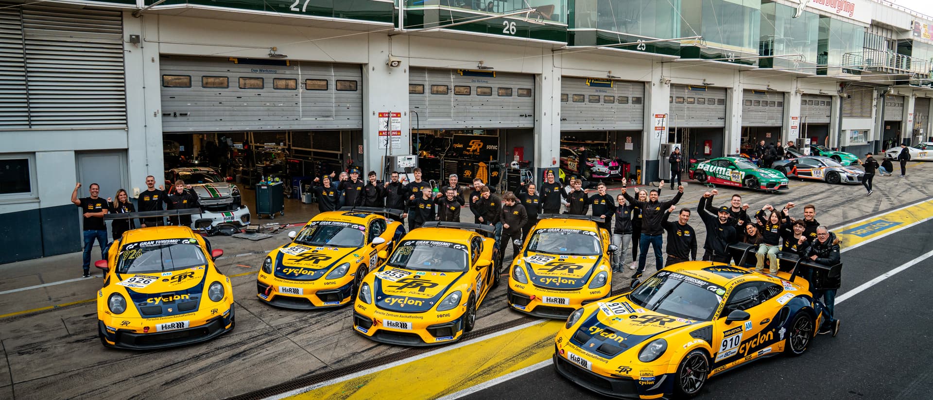 The complete Smyrlis Racing team with the fleet in the pit lane